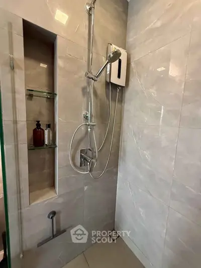 Modern bathroom with sleek shower design and built-in shelving