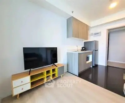Modern open-plan living room with sleek kitchen and stylish TV stand