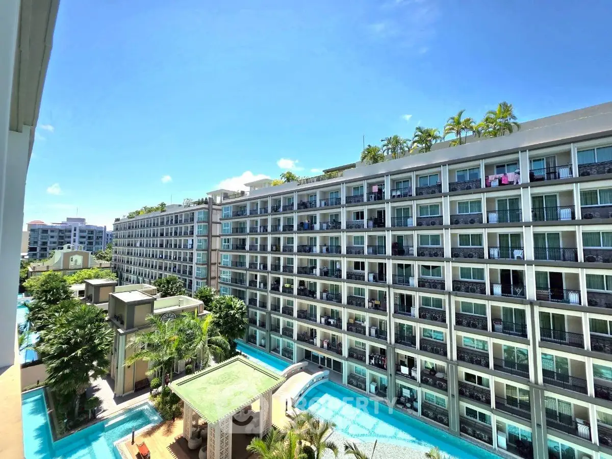 Luxurious resort-style condominium with pool and lush greenery, perfect for modern living.
