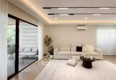 Spacious modern living room with elegant decor and large windows for natural light.