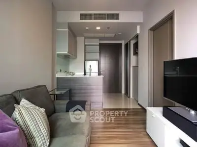 Modern living room with open kitchen layout and stylish decor