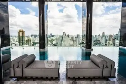 Luxurious rooftop pool with stunning city skyline view and elegant lounge chairs.