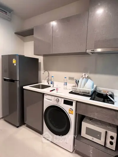 Modern kitchen with sleek appliances and ample storage space