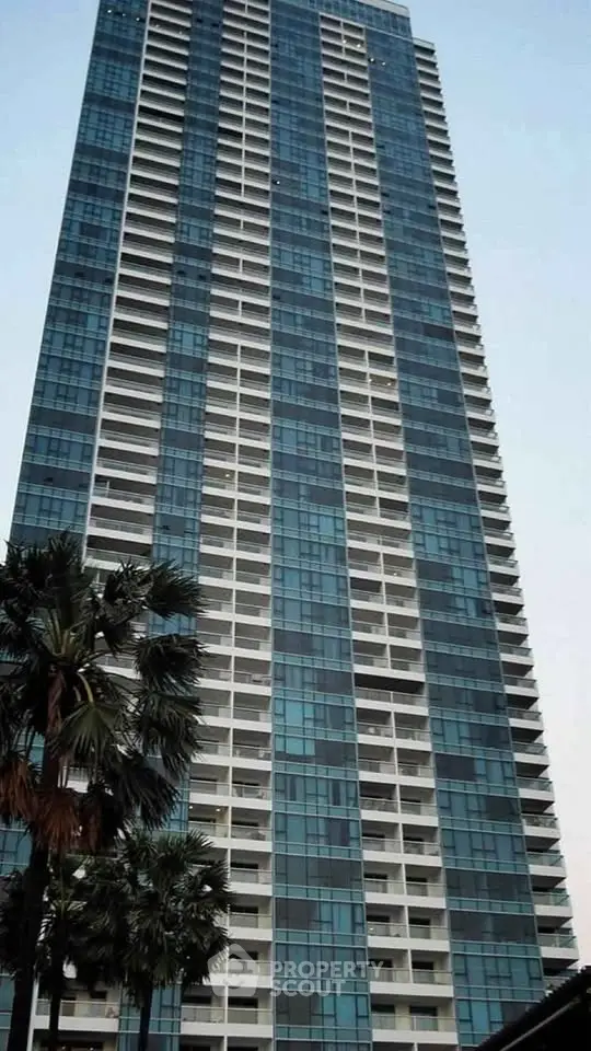 Stunning high-rise building with modern glass facade and spacious balconies