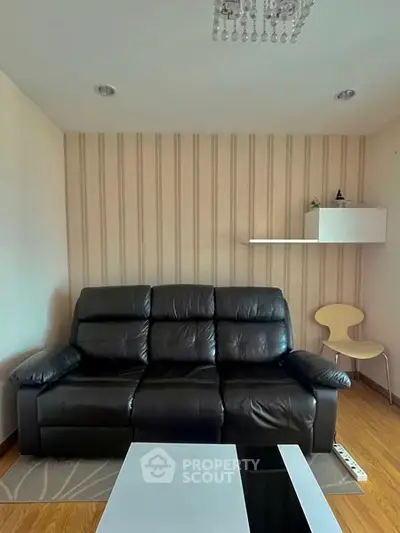 Cozy living room with modern black leather sofa and stylish decor