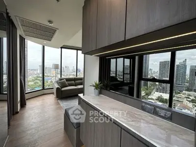 Modern living room with panoramic city views and sleek interior design.