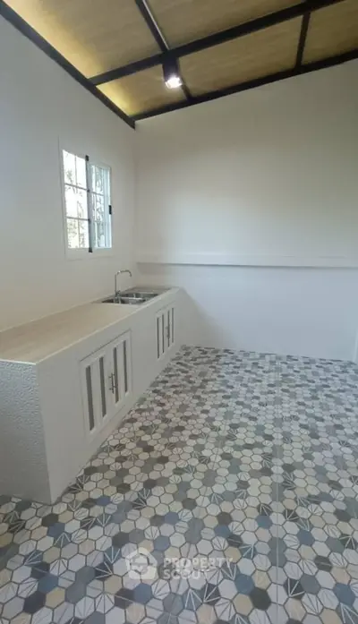 Modern kitchen with geometric tile flooring and minimalist design