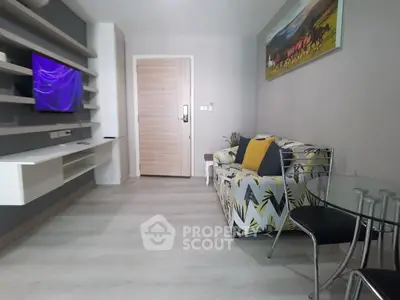 Modern living room with stylish decor and wall-mounted TV in a cozy apartment.