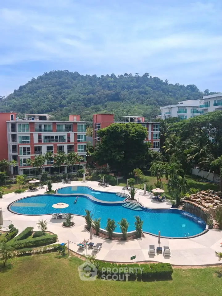 Luxurious residential complex with stunning pool and scenic mountain backdrop.