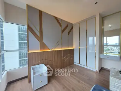 Modern bedroom with stylish wall design and large windows offering city views