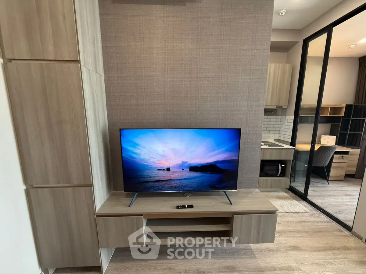 Modern living room with sleek TV unit and study area, featuring contemporary design and stylish decor.