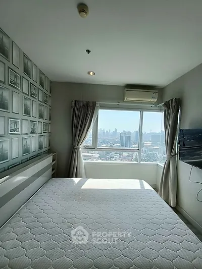 Bright bedroom with city view, featuring a large window, air conditioning, and modern decor.