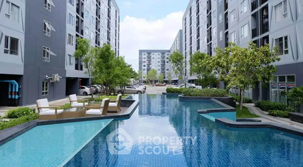 Modern apartment complex with a luxurious swimming pool and lush greenery, offering a serene urban living experience.