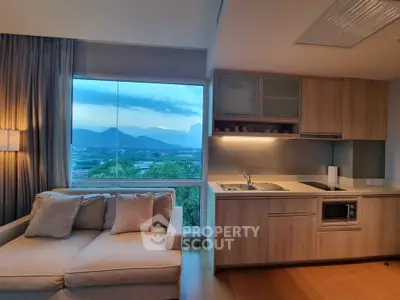 Modern living room with scenic view and stylish kitchen area