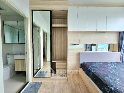 Modern bedroom with ensuite bathroom and stylish storage solutions.