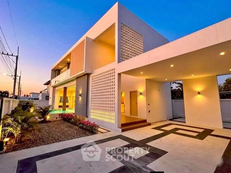 Stunning modern architectural home with elegant facade and ambient lighting at dusk.