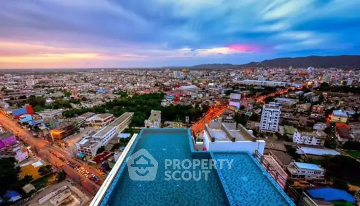 Stunning rooftop pool with panoramic city views at sunset, perfect for luxury urban living.
