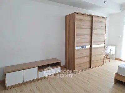 Modern minimalist bedroom with wooden wardrobe and sleek furniture