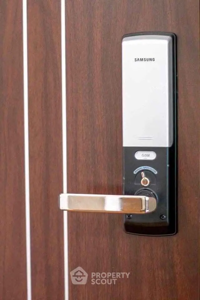 Modern electronic door lock on wooden door, enhancing security and style in real estate properties.