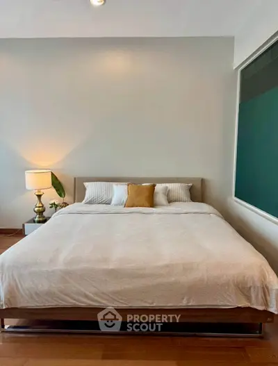 Modern bedroom with cozy bed and stylish decor in a contemporary apartment.