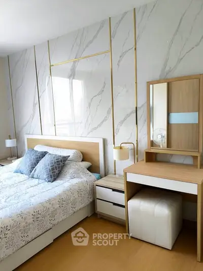 Luxurious bedroom with elegant decor and modern furnishings, featuring a stylish vanity and cozy bedding.