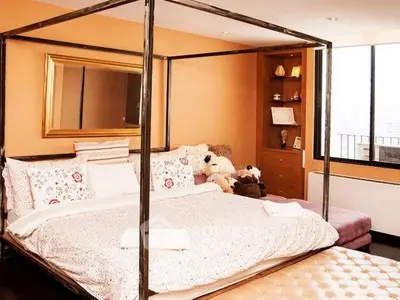 Spacious bedroom with elegant four-poster bed and plush decor
