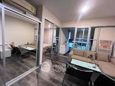 Modern living room with glass partitions and stylish furniture in a contemporary apartment.