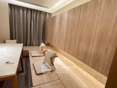 Elegant modern living room with wooden paneling and minimalist seating, perfect for a cozy and stylish home.