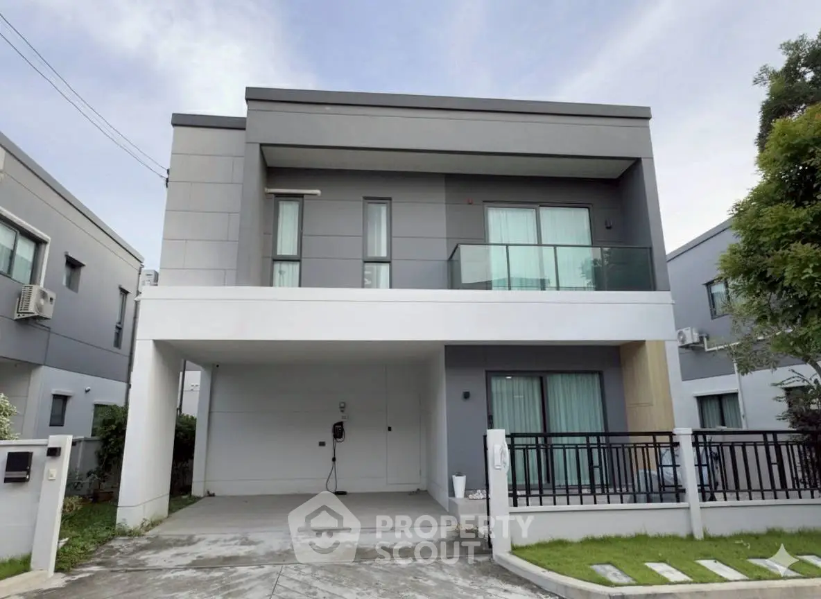 Modern two-story house with sleek design and spacious driveway