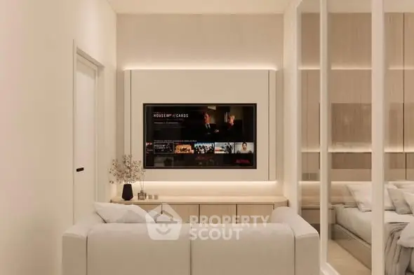 Modern living room with sleek design, featuring a wall-mounted TV and cozy white sofa.