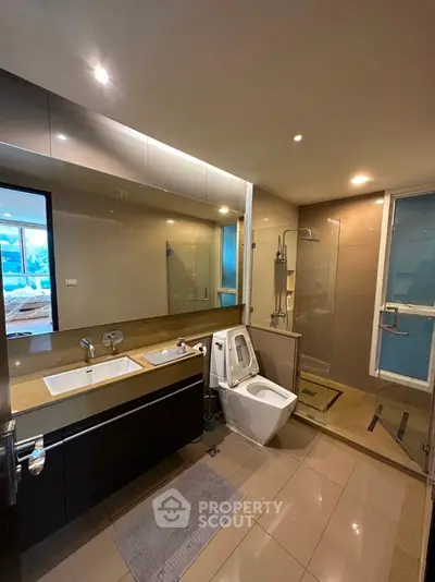 Modern bathroom with sleek fixtures and glass shower enclosure
