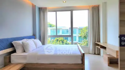 Modern bedroom with large window and scenic view in luxury apartment