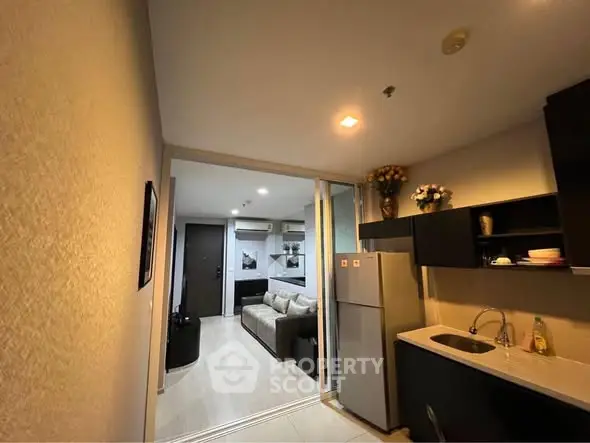 Modern apartment interior with cozy living room and compact kitchen