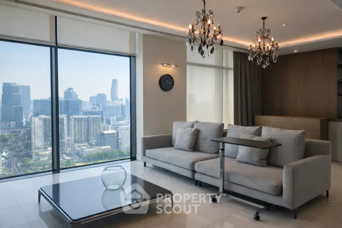 Luxurious living room with stunning city view, elegant chandeliers, and modern furnishings in high-rise apartment.