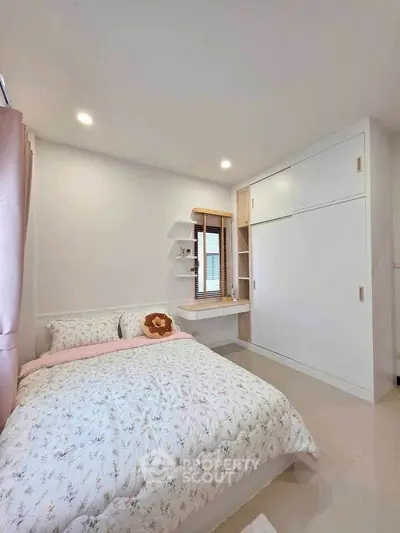 Cozy bedroom with built-in wardrobe and soft lighting