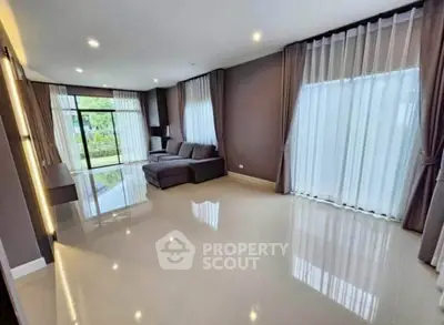 Spacious living room with large windows and modern decor