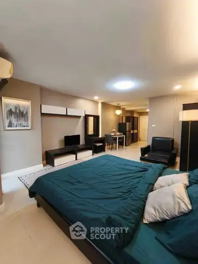 Spacious bedroom with modern furnishings and cozy ambiance