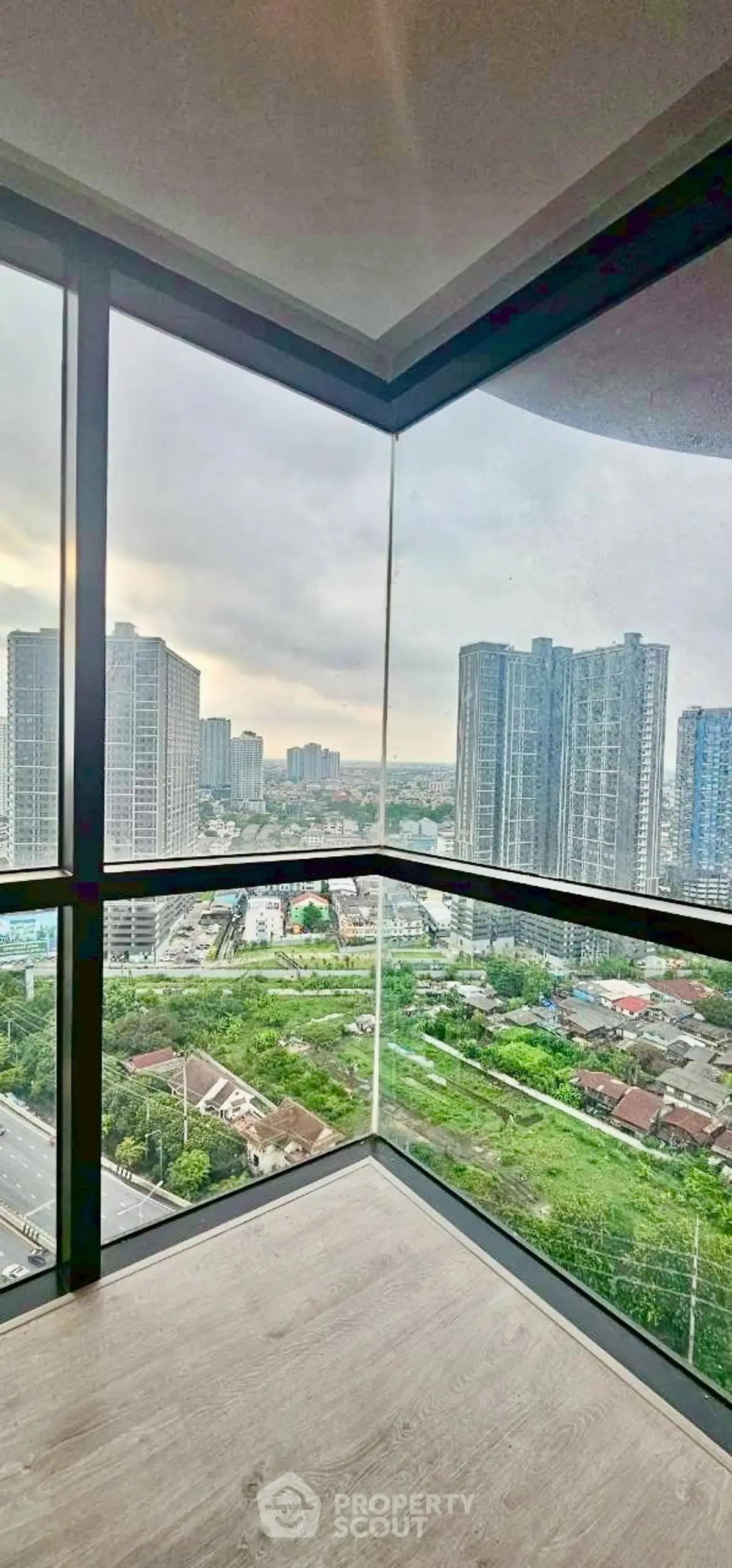 Stunning corner unit with panoramic city views from floor-to-ceiling windows.