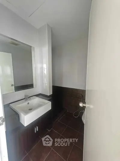 Modern bathroom with sleek sink and tiled walls, perfect for a contemporary home.