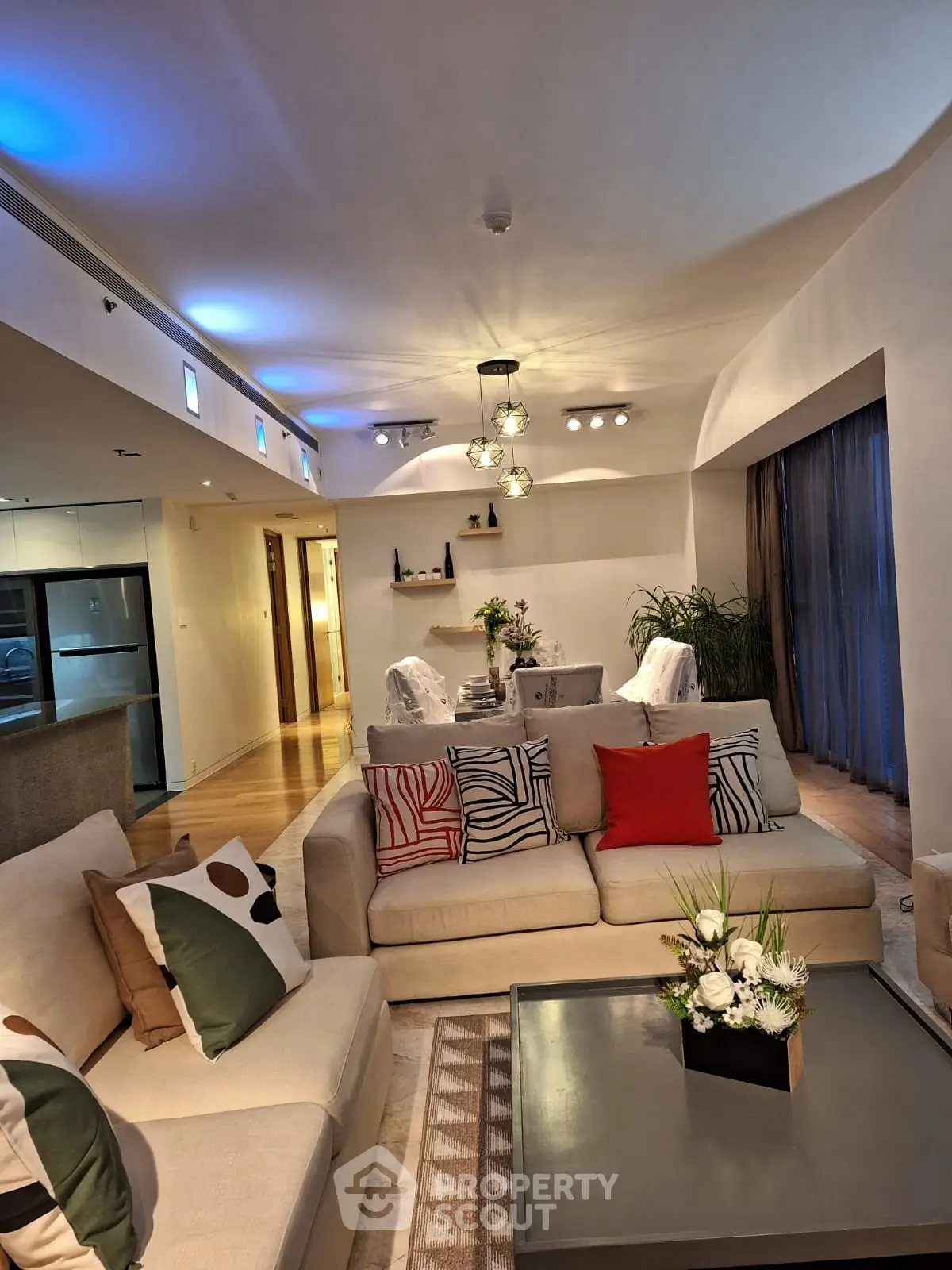 Spacious modern living room with elegant decor and ambient lighting