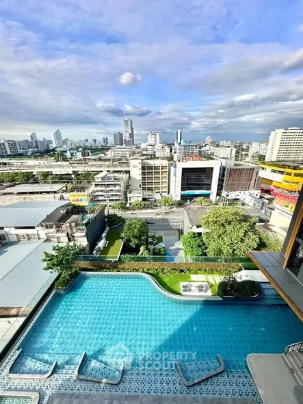Stunning city view from high-rise with luxurious pool and urban skyline.