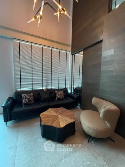 Modern living room with stylish furniture and unique lighting in a high-rise apartment.