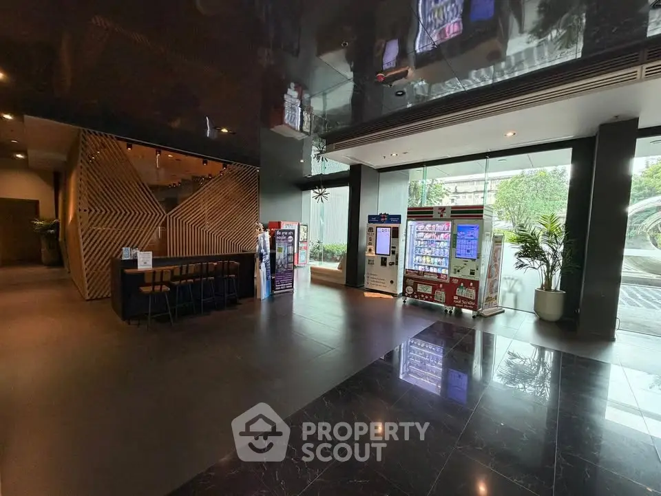 Modern building lobby with vending machines and seating area, sleek design