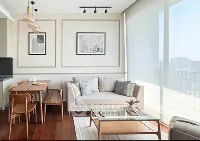 Modern living room with elegant decor and large windows offering natural light and city views.