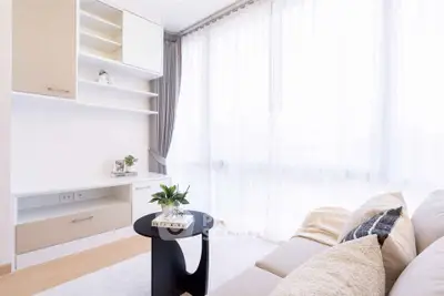 Bright and cozy living room with modern furniture and large windows.