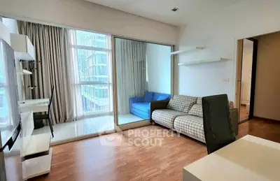 Modern living room with large windows and cozy seating area