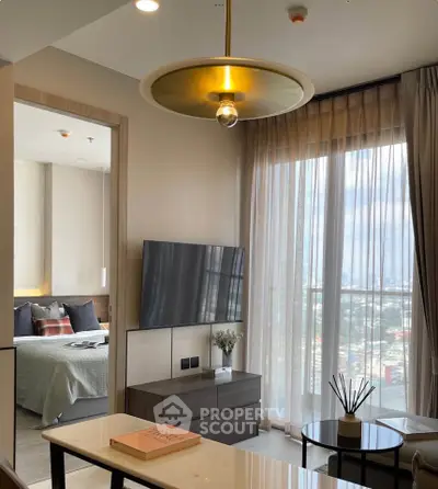 Modern living room with large window and bedroom view