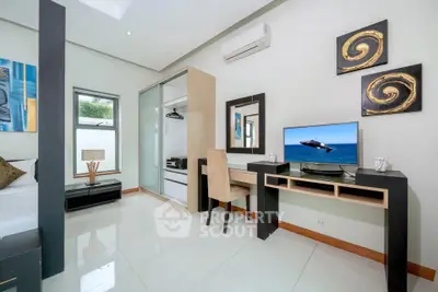 Modern bedroom with sleek design, featuring a desk, TV, and stylish decor.