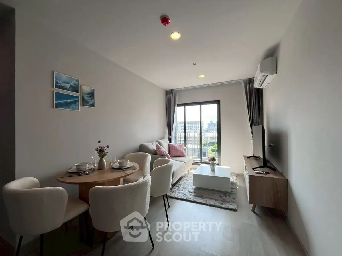 Modern living room with dining area and city view, featuring stylish furniture and natural light.
