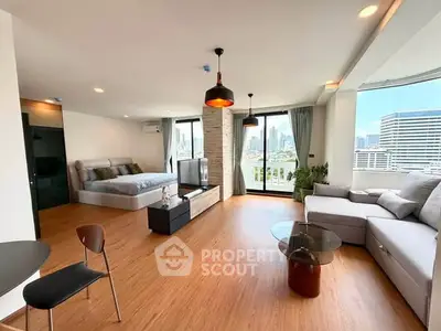 Spacious modern studio with panoramic city views and stylish furnishings.